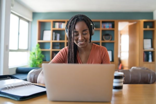 portrait-woman-video-call-with-laptop-headphones-while-working-from-home-concept_58466-15494